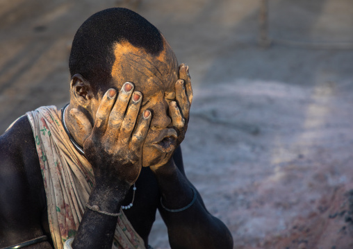 Mundari tribe man covering his body in ash to repel flies and mosquitoes, Central Equatoria, Terekeka, South Sudan