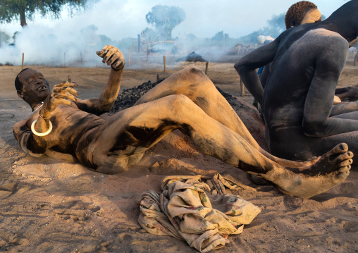 Mundari tribe men covering their bodies in ash to protect from the mosquitoes and flies bites, Central Equatoria, Terekeka, South Sudan