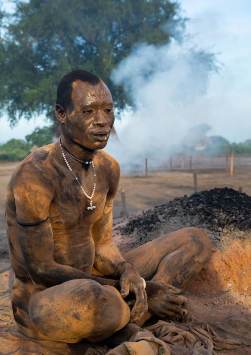 Mundari tribe man covering his body in ash to repel flies and mosquitoes, Central Equatoria, Terekeka, South Sudan