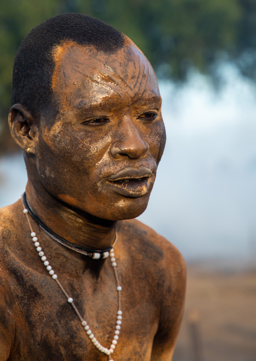 Mundari tribe man covering his body in ash to repel flies and mosquitoes, Central Equatoria, Terekeka, South Sudan