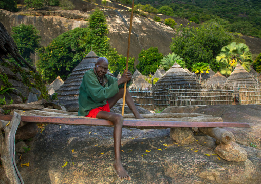 Lotuko tribe man resting on a wooden bed, Central Equatoria, Illeu, South Sudan