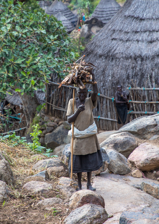 Lotuko tribe woman carrying wood on her head, Central Equatoria, Illeu, South Sudan