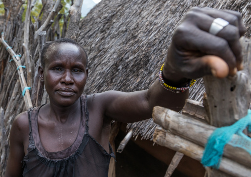Woman in front of a Lotuko tribe thatched house, Central Equatoria, Illeu, South Sudan