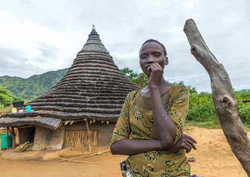 Larim tribe woman in front of her traditional house, Boya Mountains, Imatong, South Sudan
