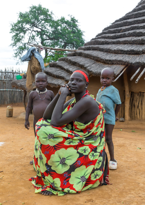 Larim tribe woman with her children in front of her traditional house, Boya Mountains, Imatong, South Sudan