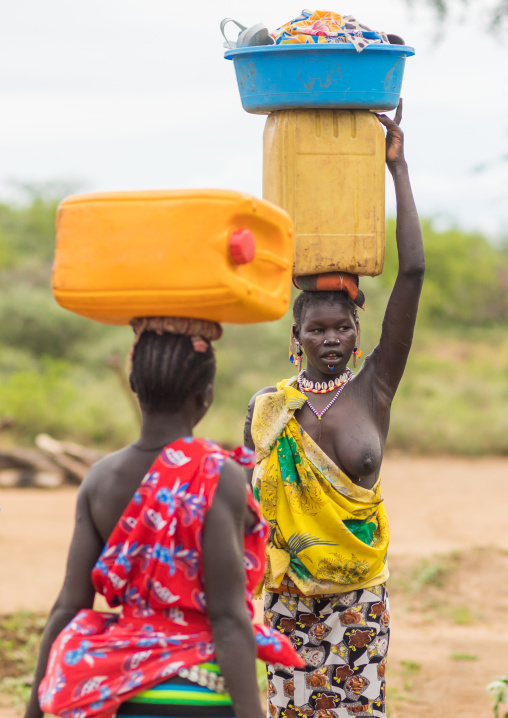 Portrait of a Larim tribe women carrying a yellow jerrican on the heads, Boya Mountains, Imatong, South Sudan