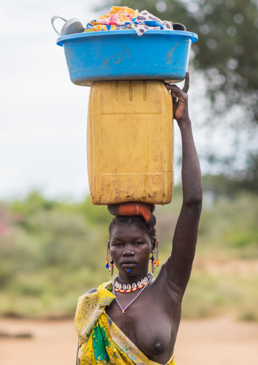 Portrait of a Larim tribe woman carrying a yellow jerrican on the head, Boya Mountains, Imatong, South Sudan