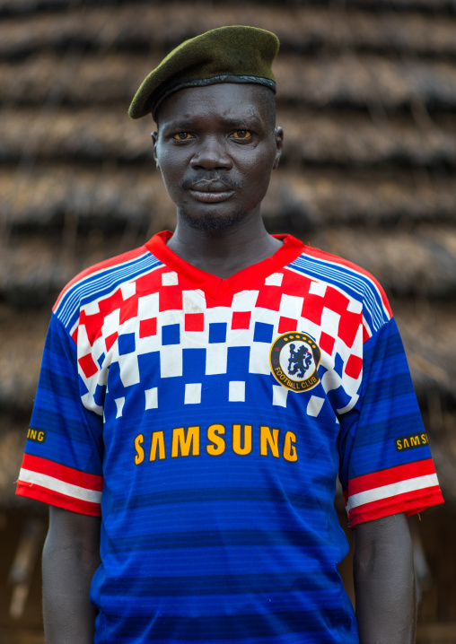 Portrait of a former soldier from Larim tribe wearing a chelsea football shirt, Boya Mountains, Imatong, South Sudan