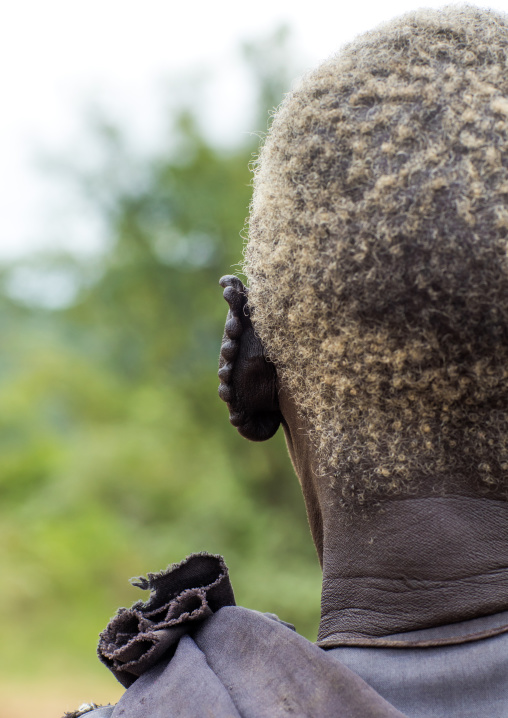 Lotuko tribe old woman with the ears cut in the same way they do to their cows as decoration, Central Equatoria, Illeu, South Sudan