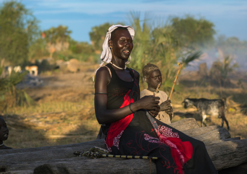 Portrait of a Mundari tribe woman sit on a bed, Central Equatoria, Terekeka, South Sudan