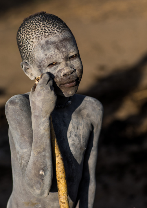 A Mundari tribe boy covered in ash to repel flies and mosquitoes, Central Equatoria, Terekeka, South Sudan