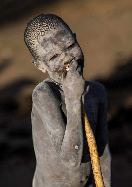 Smiling Mundari tribe boy covered in ash to repel flies and mosquitoes, Central Equatoria, Terekeka, South Sudan