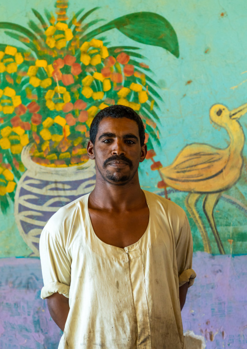 Sudanese man in a restaurant with decorated walls, Khartoum State, Khartoum, Sudan