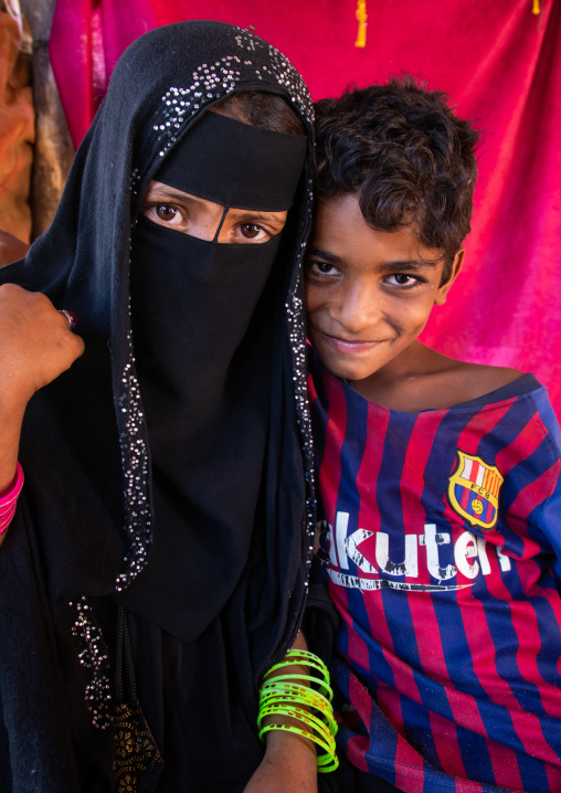 Rashaida veiled girl and a boy wearing a Barcelona football shirt, Kassala State, Kassala, Sudan