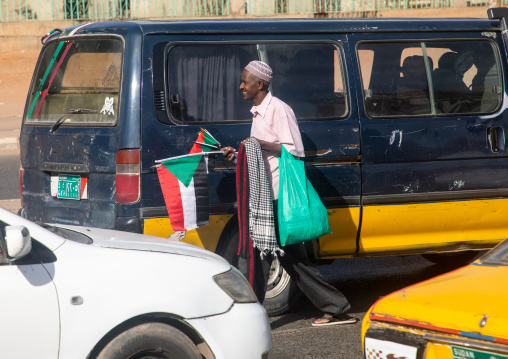 Man selling sudanese flags in the street, Khartoum State, Khartoum, Sudan