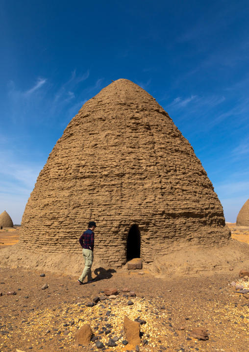 Tourists in front of a beehive tomb, Nubia, Old Dongola, Sudan
