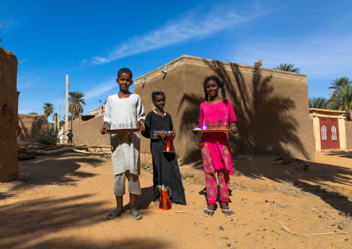 Sudanese children offering tea to visitors in a village, Northern State, Karima, Sudan