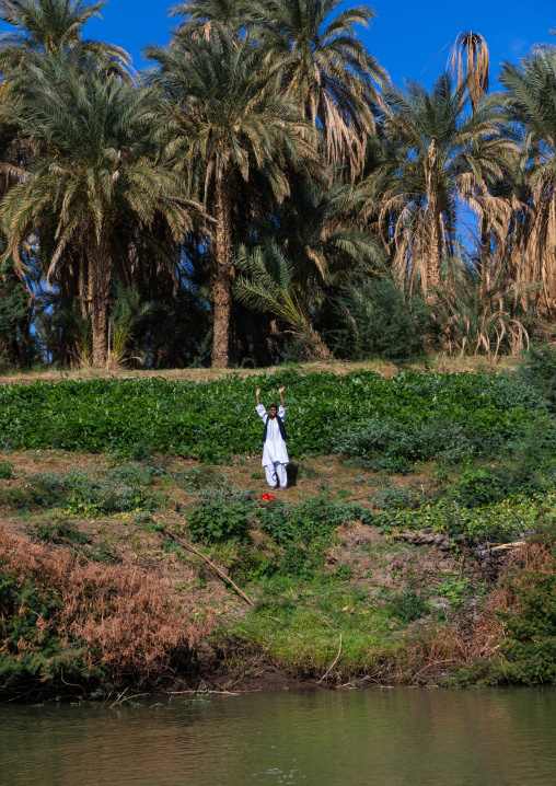 Sudanese man gardening on the bank of river Nile, Northern State, El-Kurru, Sudan