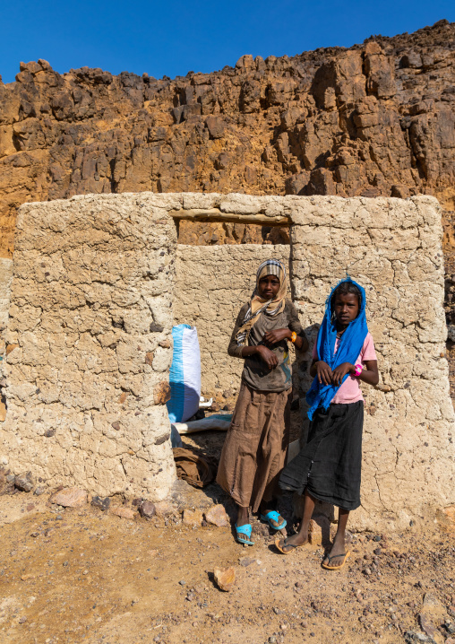 Bisharin nomad girls collecting salt in Atrun crater, Bayuda desert, Atrun, Sudan