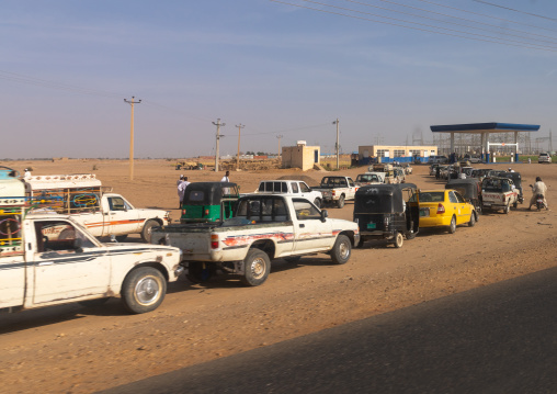 Sudanese people in their cars queue on line at a gas station during the fuel shortages, Northern State, Meroe, Sudan