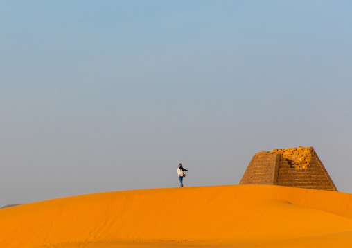 Tourist visiting the pyramids of the kushite rulers at Meroe, Northern State, Meroe, Sudan