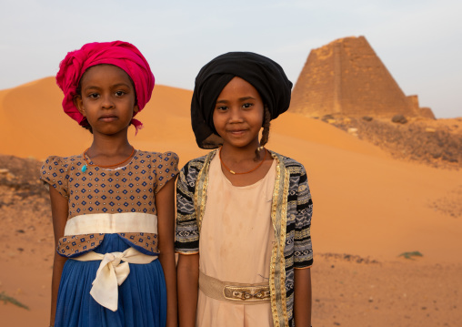 Portrait of sudanese girls visiting the pyramids of the kushite rulers at Meroe, Northern State, Meroe, Sudan