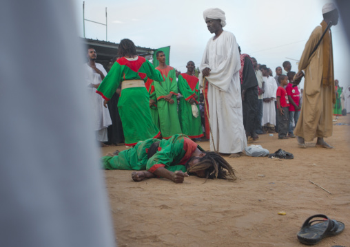 Sudan, Khartoum State, Khartoum, sufi dervish lying on the ground at omdurman sheikh hamad el nil tomb