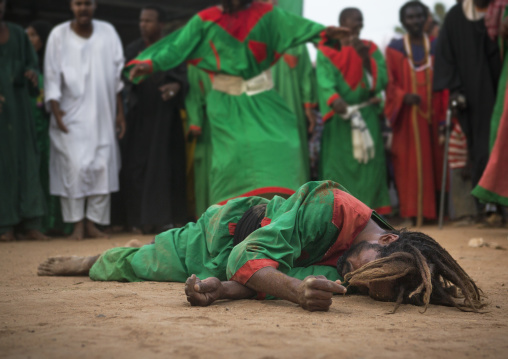 Sudan, Khartoum State, Khartoum, sufi dervish lying on the ground at omdurman sheikh hamad el nil tomb