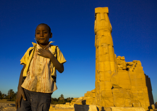 Sudan, Nubia, Soleb, kid in front of the big soleb temple built by amenophis iii