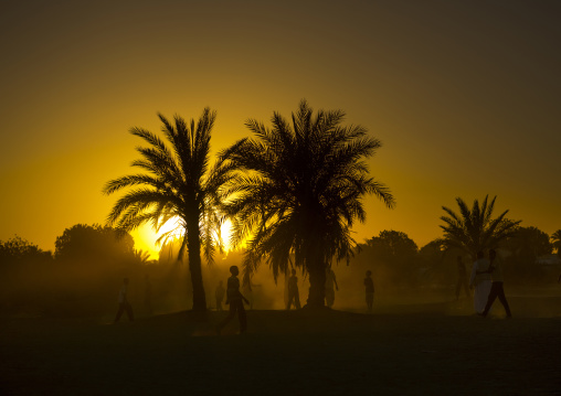 Sudan, Nubia, Tumbus, kids playing football in the desert at sunset