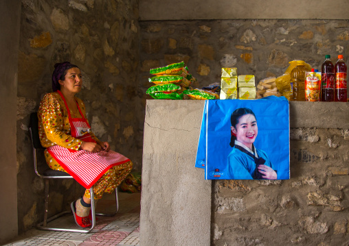 Tajik woman selling food and drinks in the market border with Aghanistan, Central Asia, Ishkashim, Tajikistan