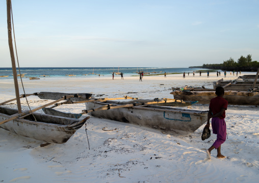 Tanzania, Zanzibar, Matemwe, wooden fishing dhows resting on a sandy beach
