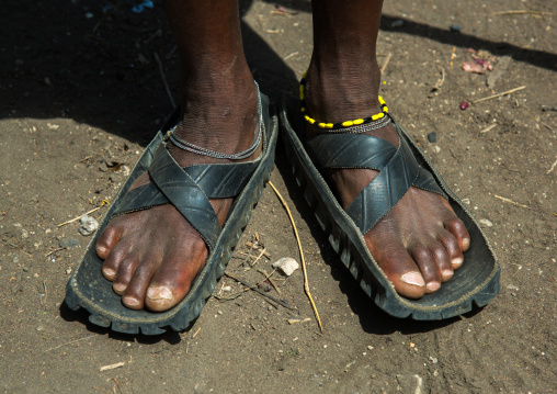 Tanzania, Ashura region, Ngorongoro Conservation Area, close up of leather sandals and intricate beadwork on the maasai men feet