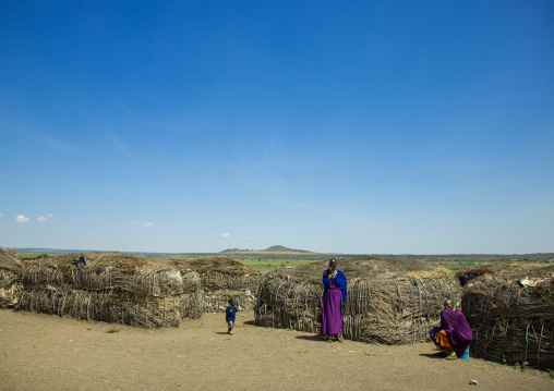 Tanzania, Ashura region, Ngorongoro Conservation Area, maasai women with child outside their home