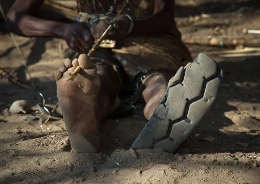Tanzania, Serengeti Plateau, Lake Eyasi, hadzabe tribe man shoes made from a car tyre