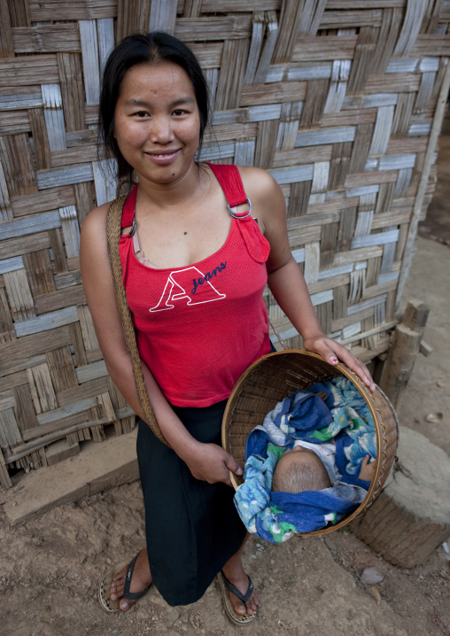 Karen woman carrying her baby in a basket, North thailand