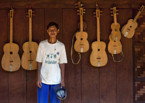 Karen man selling guitars, Nam peang din village, Thailand