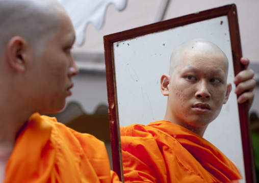 Novice looking at himself in a mirror, Bangkok thailand