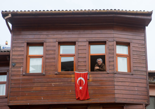 Smiling woman in her old wooden style house near the Bosphorus sea, Marmara Region, istanbul, Turkey