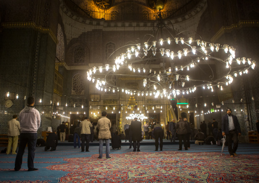 Muslim men praying inside new mosque Yeni Camii, Marmara Region, istanbul, Turkey