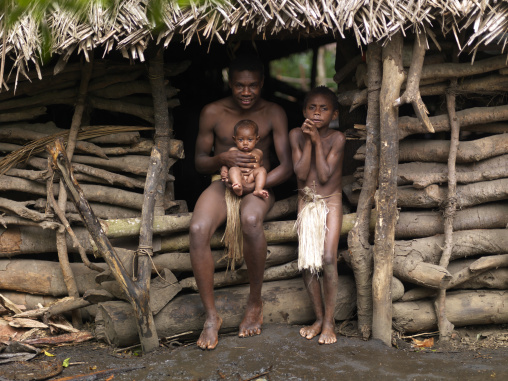 Charly Kala and his nephews from the Big Nambas tribe in front of their house, Tanna island, Yakel, Vanuatu