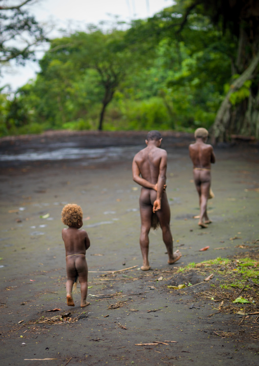 Three generations from the Big nambas tribe walking in a village, Tanna island, Yakel, Vanuatu