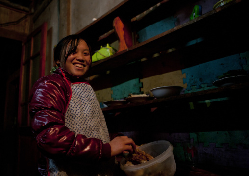 Woman smiling while cooking, Sapa, Vietnam