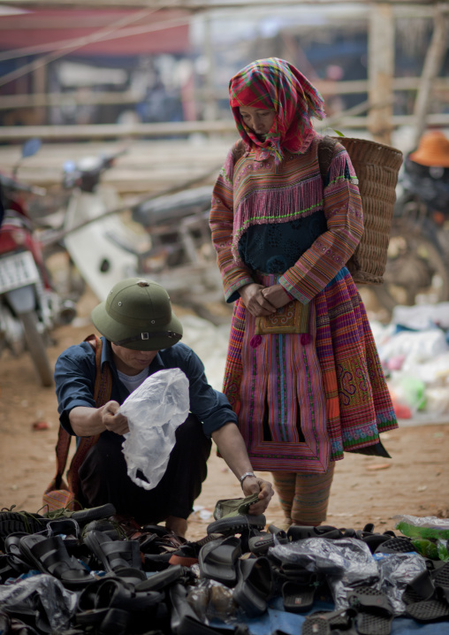 Flower hmong woman looking for shoes, Sapa market, Vietnam
