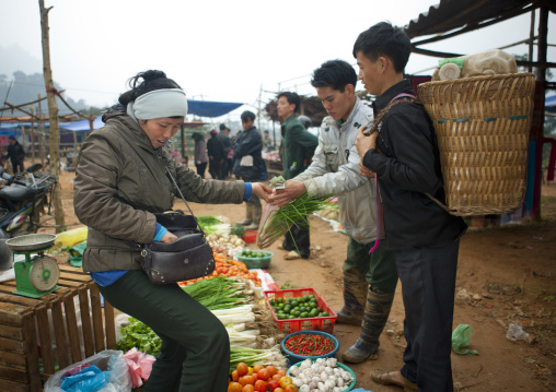 Woman buying vegetables at sapa market, Vietnam