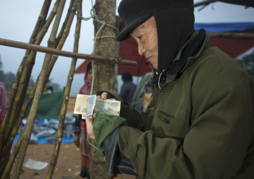 Old man showing the money he earned, Sapa, Vietnam