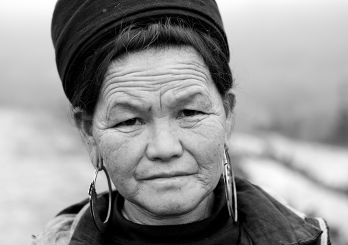 Black hmong woman with traditional hat and earrings, Sapa, Vietnam