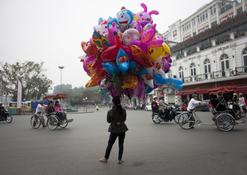 Woman selling balloons in the street, Hanoi, Vietnam