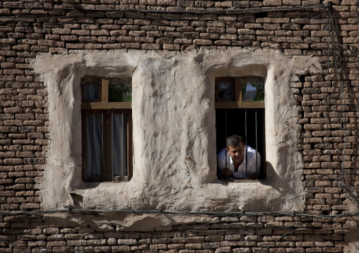 Man Looking Out From The Window Of A Typical Residential House, Sana, Yemen