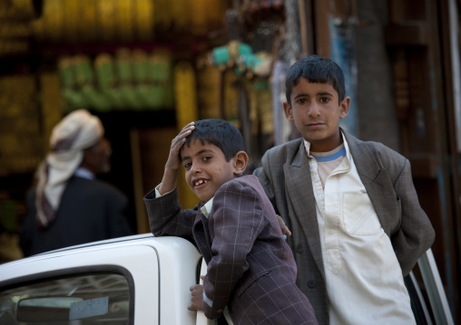 Two Boys Leaning On A Car In The Street, Sanaa, Yemen